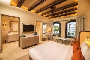 a bedroom with a bed and a living room at Cunda Callisto Hotel & Spa Adult Only 12 in Ayvalık +66 photos
