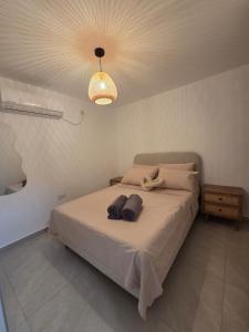 a bedroom with a bed with two towels on it at Atalya Suite in Eilat