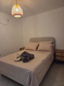 a bedroom with a bed with a stuffed animal on it at Atalya Suite in Eilat