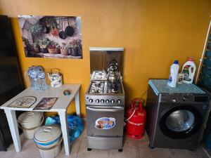 a kitchen with a stove and a washing machine at The Graziano 2 house in Sousse