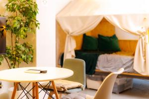 a room with a table and a bed with a canopy at Hotel Ougien in Tokyo