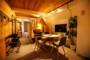 a room with a bed and a table and chairs at Hotel Ougien in Tokyo