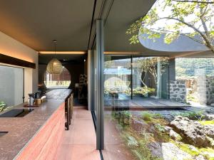 a kitchen in a house with a large window at 제주 감성숙소 스테이보스케 in Jeju +27 photos