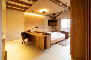 a bedroom with a bed and a desk with a bed gmaxwell gmaxwell gmaxwell at Hotel Schönblick in Rodengo +66 photos