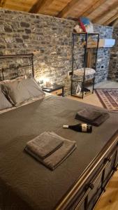 a bed with a bottle of wine on top of it at Black Rock Agria in Agria