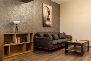 a living room with a couch and a table at Апартамент 8 in Lovech
