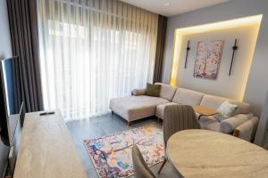 a living room with a couch and a table at Boamonti Residence Sisli Apart in Istanbul