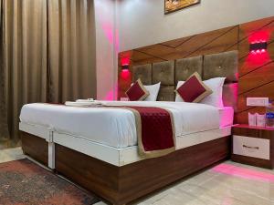 a bedroom with a large bed with a wooden headboard at Hotel Full Moon Night in Dalhousie +54 photos