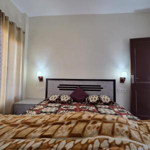 a bedroom with a bed with a comforter and pillows at The Sunrise Retreat in Solan
