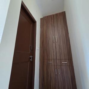 a bedroom with a wooden cabinet and a door at The Sunrise Retreat in Solan