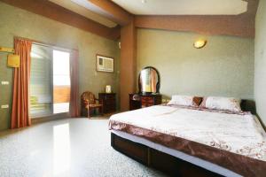 Postel nebo postele na pokoji v ubytování Jheng Tong House