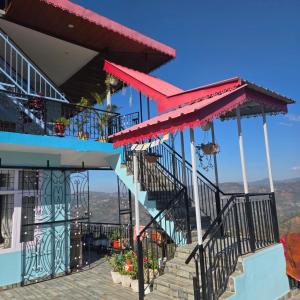 a building with stairs and red accents on it at The Sunrise Retreat in Solan