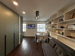 a living room with a couch and a dining room at Panoramic River View I Spacious Modern 2BR Apartment in Riga
