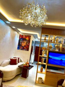 a living room with a couch and a chandelier at Afalux Brand chic in Agadir
