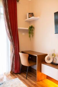 a desk and a chair in a room at Mivida Residences in Bulindo