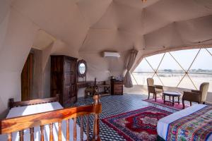 a room with a bed and a table and chairs at Crystal Resort in Sām