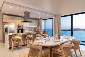 a dining room and kitchen with a table and chairs at 3082 - Paradise Cove 3A Manzanillo in Tangolunda