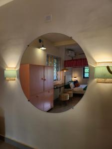 a room with a circular mirror on the wall at Florin Studio in Vagator
