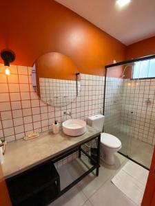 a bathroom with a sink and a toilet and a mirror at Pousada Primavera in Parnaíba +21 photos