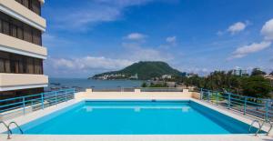 a swimming pool on top of a building with a view of the ocean at Vung Tau P&T Hotel in Vung Tau