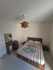 a bedroom with a bed and a table and a lamp at مراسي in Sīdī ‘Abd ar Raḩmān
