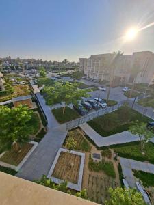 an aerial view of a parking lot with cars and trees at مراسي in Sīdī ‘Abd ar Raḩmān