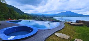 a swimming pool with a view of a lake and mountains at Adelisca Glamping, Cafe and Villa in Kubupenlokan