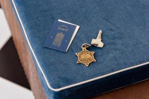 a gold medal on top of a blue book at Hôtel de la Comète in Paris