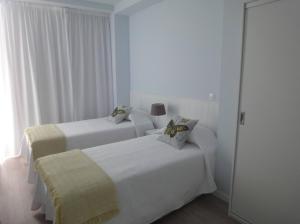 Postel nebo postele na pokoji v ubytování QUO Almeida Garrett