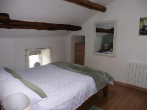 a bedroom with a white bed and a mirror at tillys Cottage in Folles