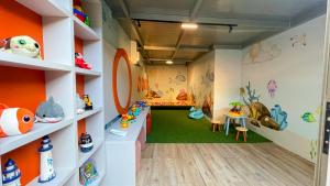 a room filled with lots of toys on shelves at W Tambaú Apart Hotel in João Pessoa