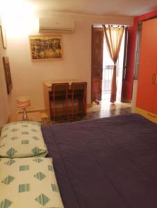 a bedroom with a bed and a table and chairs at Tomicla in Monreale