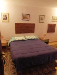 a bedroom with a large purple bed in a room at Tomicla in Monreale