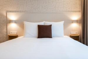 Giường trong phòng chung tại Hotel Zest Den Haag - Scheveningen