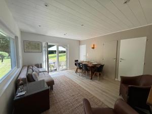 a living room with a couch and a table at Chalet Woodyoustay in Theux