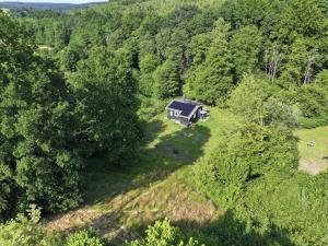 an aerial view of a house in the middle of a forest at Chalet Woodyoustay in Theux
