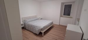 a small bedroom with a bed and a window at Casa vacanza del Cavallo in Senigallia
