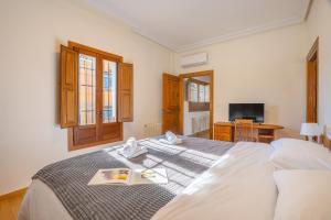 a bedroom with a bed with a book on it at Sueños De La Vega in Las Gabias