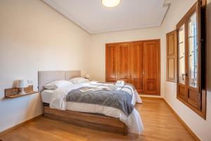 a bedroom with a bed and a wooden floor at Sueños De La Vega in Las Gabias
