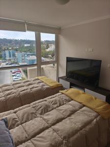 En eller flere senge i et værelse på Departamento Reñaca Bajo