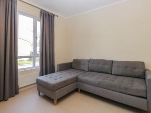 a living room with a couch and a window at Beechtree Timber Lodge 69B in Denny +2 photos