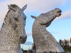 a statue of two horses standing next to each other at Beechtree Timber Lodge 69B in Denny