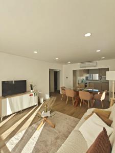 a living room with a couch and a table at Refugio do Surf Cortegaça in Cortegaça