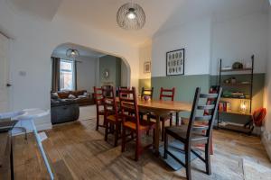 a dining room and living room with a table and chairs at The Salty Seagull in Scarborough