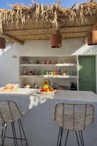 a kitchen with a table and two chairs at Riad Dar Tiflet in Marrakesh