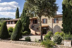 a large stone house with trees in front of it at Villa Sant 'Angelus in Canonica