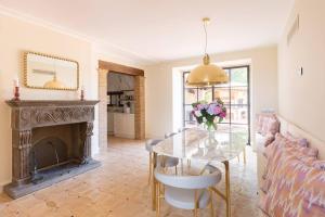 a living room with a glass table and a fireplace at Villa Sant 'Angelus in Canonica