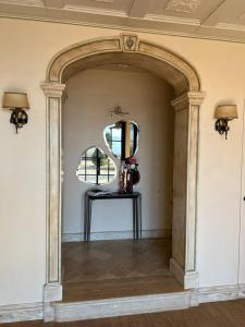 an archway in a room with a mirror and a table at Villa Sant 'Angelus in Canonica +72 photos