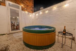 a hot tub in a room with a bottle of wine at The Salty Seagull in Scarborough