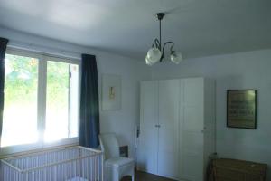 a living room with a window and a chandelier at House on the hill, near Aubeterre-sur-dronne in Saint-Romain +15 photos